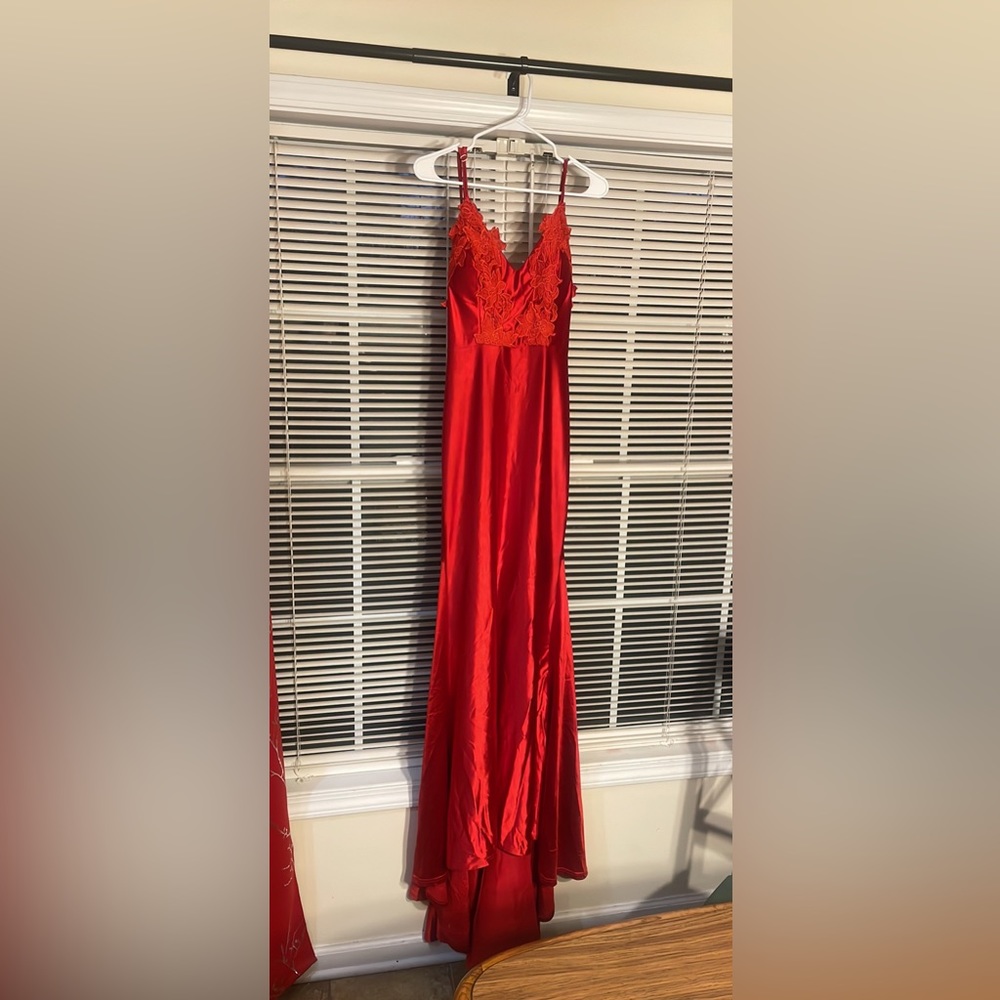 Red floor length gown. Has a decent train and has some stretch to the fabric